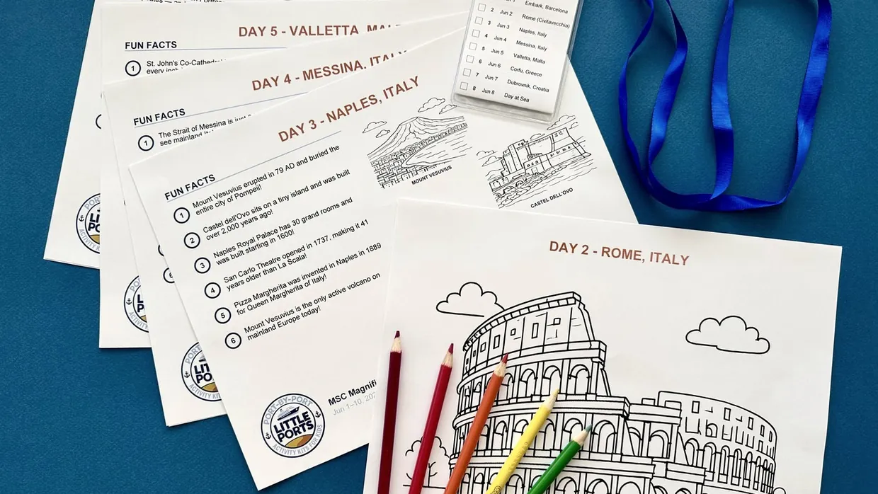 Little Ports port cards fanned out with a lanyard itinerary and colored pencils